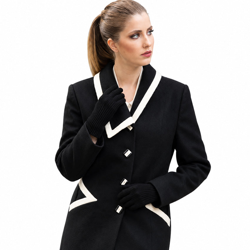 Woman wearing black pure cashmere gloves with a handcrafted black wool coat by Moda de la Maria.