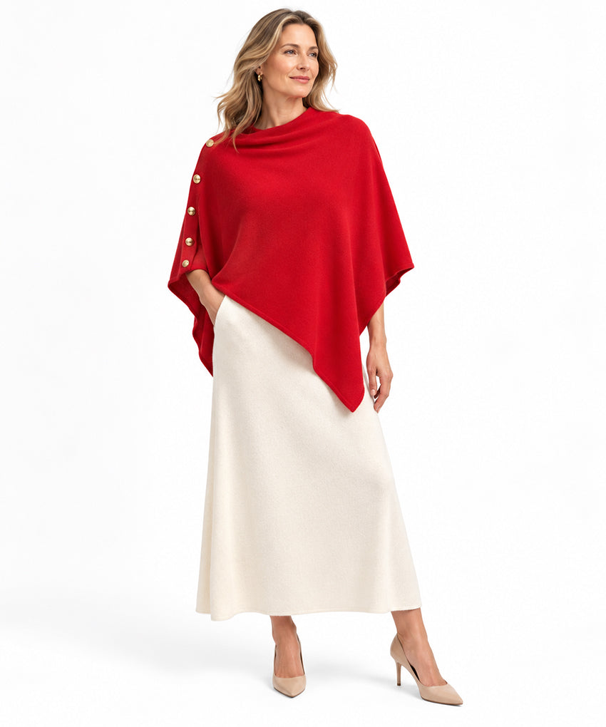 Woman wearing red pure cashmere poncho shawl with side buttons, styled with white skirt by Moda de la Maria